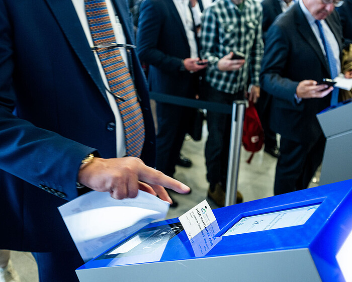 WindEnergy Hamburg 2024 / Visitors scanning tickets at Central Foyer